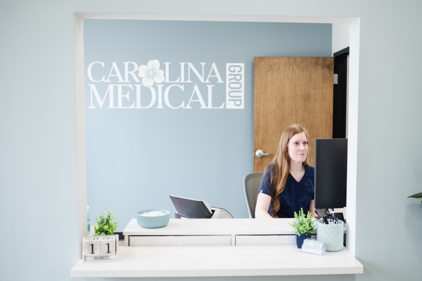 Darcy Martin helping patients at the Carolina Medical Group front desk